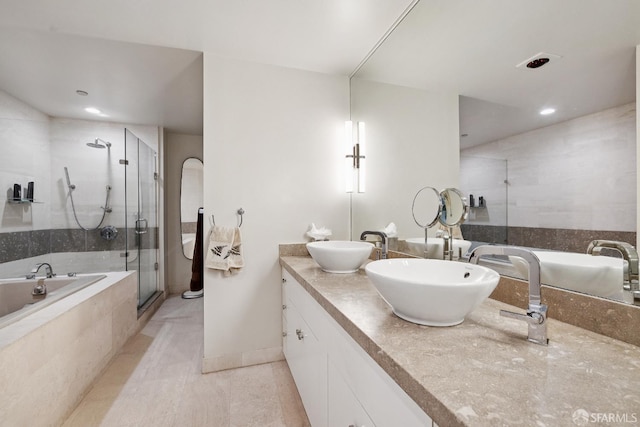 611 Washington St Unit 2505, San Francisco, CA 94111 - bathroom with double vanity, a garden tub, a stall shower, tile patterned flooring, and recessed lighting