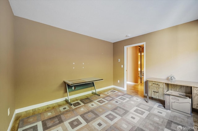 laundry area with light hardwood / wood-style floors