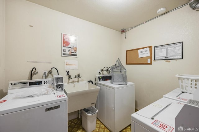 laundry room featuring washing machine and clothes dryer and sink