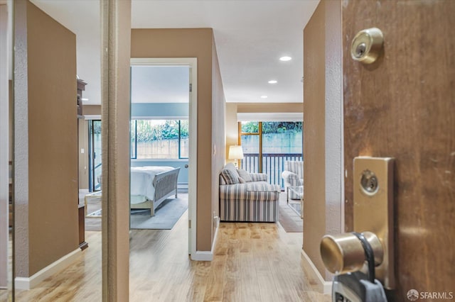 corridor with light hardwood / wood-style floors