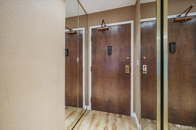 hall with light hardwood / wood-style flooring