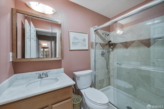 bathroom featuring walk in shower, vanity, and toilet