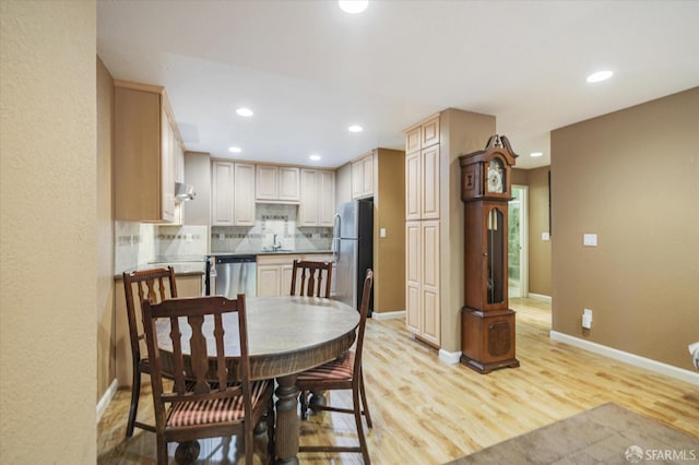 dining room featuring light hardwood / wood-style floors and sink