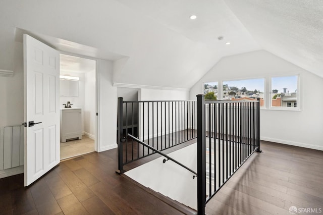 63-65 Jersey St, San Francisco, CA 94114 - hall with an upstairs landing, wood-type flooring, radiator heating unit, lofted ceiling, and recessed lighting