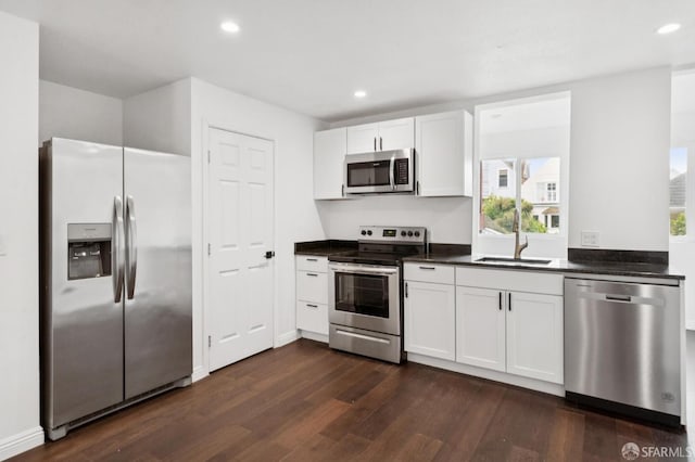 63-65 Jersey St, San Francisco, CA 94114 - kitchen featuring stainless steel appliances, dark countertops, dark wood-style flooring, recessed lighting, and white cabinetry