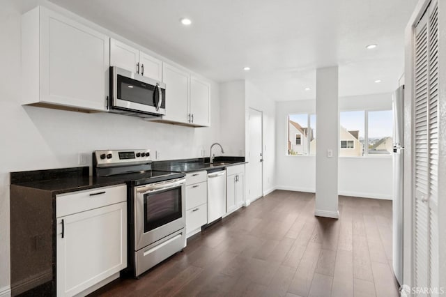 63-65 Jersey St, San Francisco, CA 94114 - kitchen featuring stainless steel appliances, dark countertops, white cabinets, dark wood-style floors, and recessed lighting