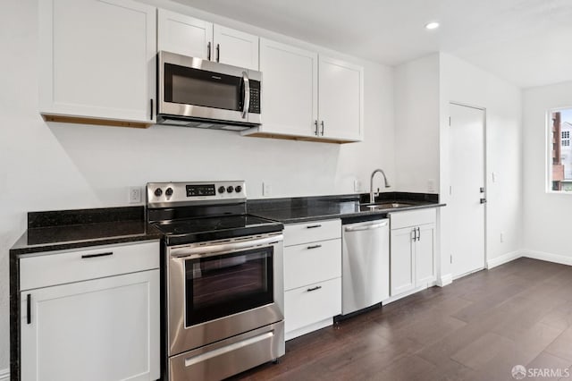 63-65 Jersey St, San Francisco, CA 94114 - kitchen featuring appliances with stainless steel finishes, dark wood-type flooring, white cabinetry, recessed lighting, and dark stone counters