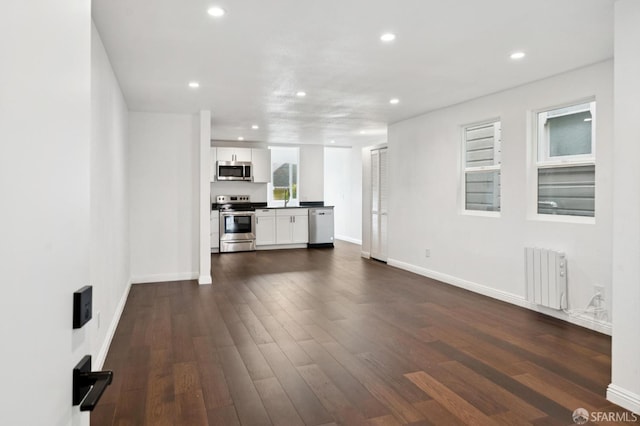 63-65 Jersey St, San Francisco, CA 94114 - unfurnished living room featuring radiator, recessed lighting, and dark wood-type flooring