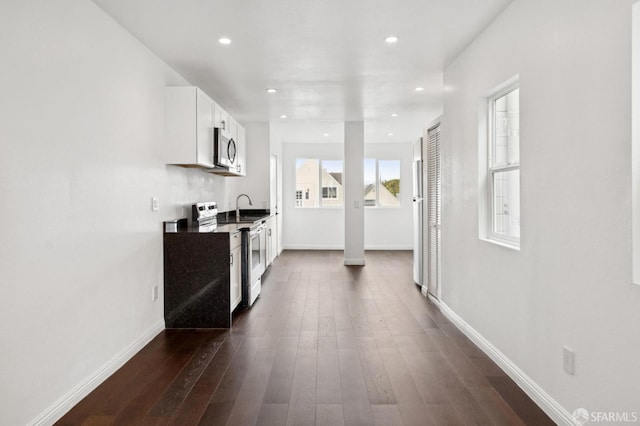 63-65 Jersey St, San Francisco, CA 94114 - kitchen with stainless steel appliances, white cabinets, dark wood finished floors, and recessed lighting
