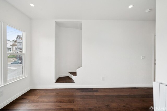 63-65 Jersey St, San Francisco, CA 94114 - empty room with radiator, wood finished floors, a smoke detector, recessed lighting, and stairs