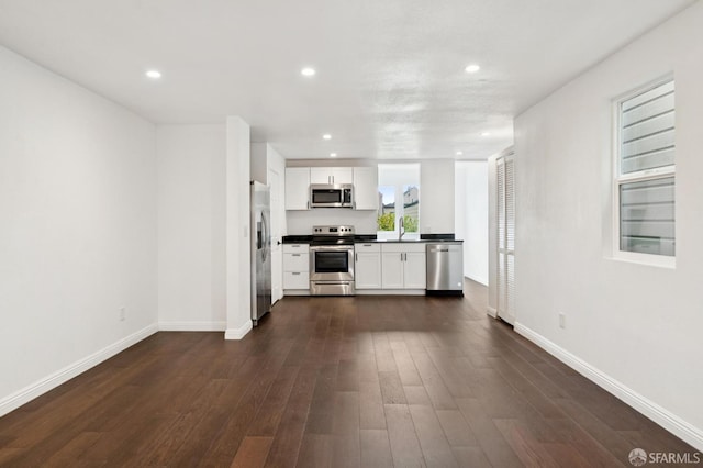 63-65 Jersey St, San Francisco, CA 94114 - kitchen featuring appliances with stainless steel finishes, dark countertops, dark wood finished floors, recessed lighting, and white cabinetry