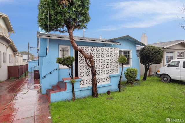 view of front of property with a front yard and fence