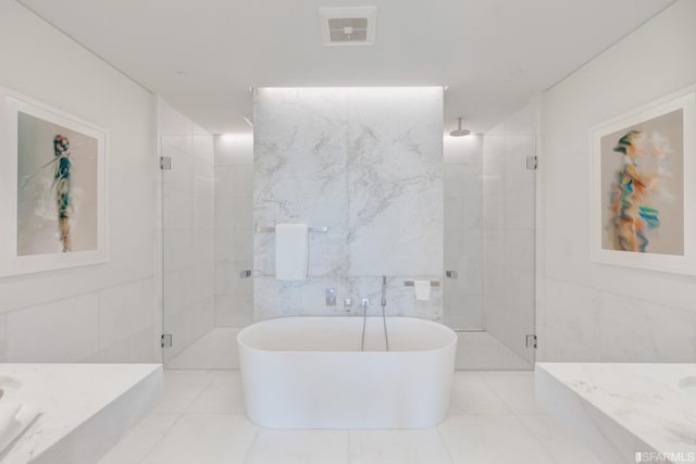 bathroom with plus walk in shower, vanity, tile walls, and tile patterned flooring