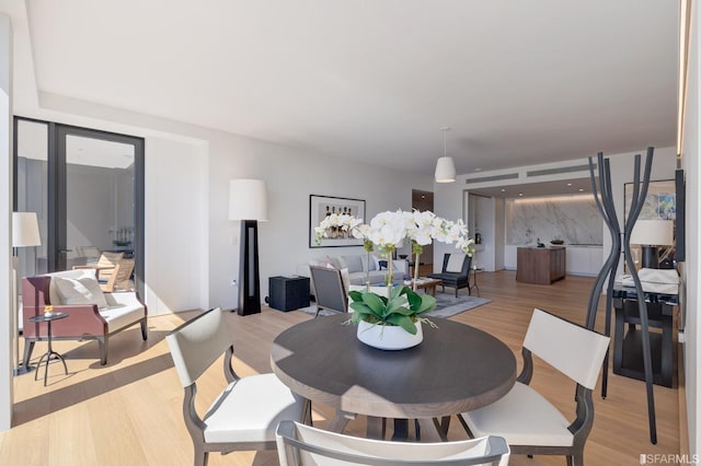 dining area with light hardwood / wood-style floors