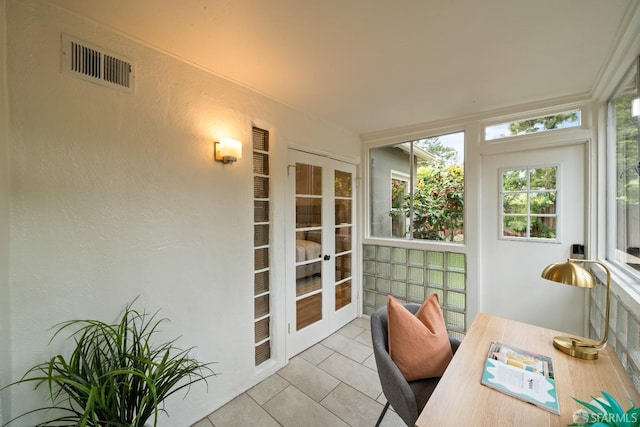 sunroom featuring tile patterned floors, visible vents, and french doors