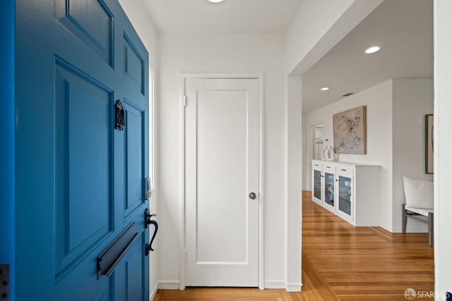 corridor with recessed lighting, light wood-style flooring, and baseboards