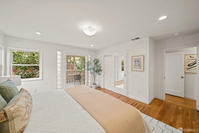 bedroom with recessed lighting, visible vents, wood finished floors, and baseboards