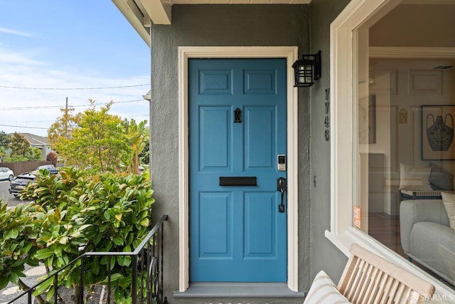 view of exterior entry with stucco siding