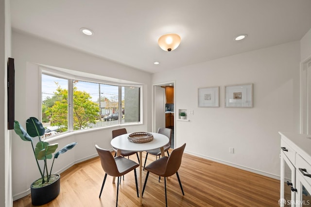 dining space featuring recessed lighting, baseboards, and light wood-style floors