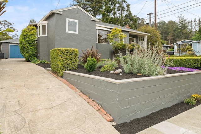 view of home's exterior featuring stucco siding and an outbuilding