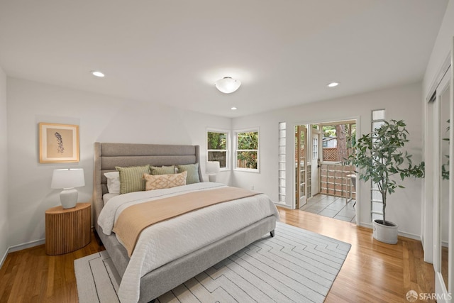 bedroom featuring recessed lighting, wood finished floors, and baseboards
