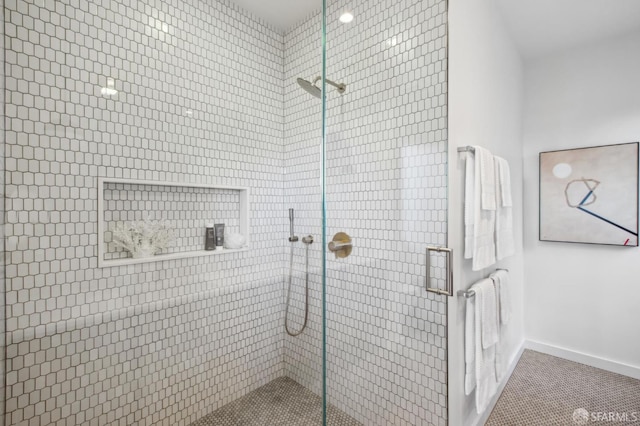 bathroom with tile patterned floors and a shower with door