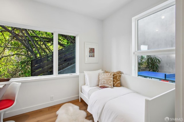 bedroom with hardwood / wood-style flooring