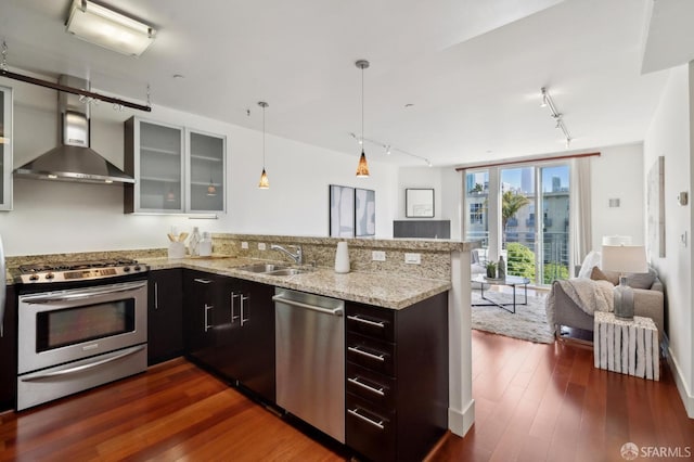 75 Moss St Unit 14, San Francisco, CA 94103 - kitchen with appliances with stainless steel finishes, wall chimney range hood, a sink, track lighting, and open floor plan
