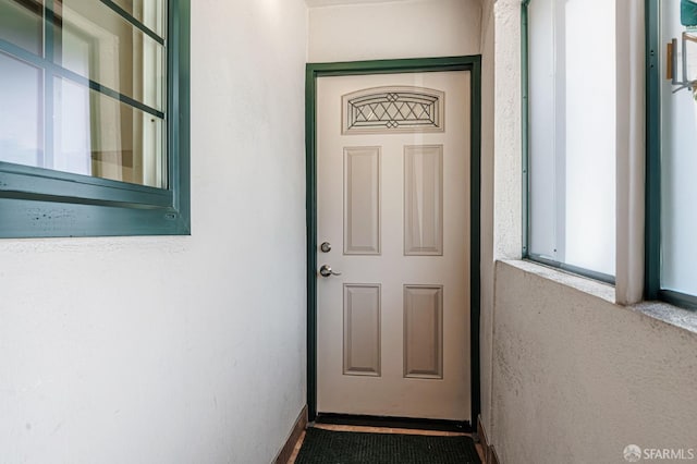 entrance to property featuring stucco siding