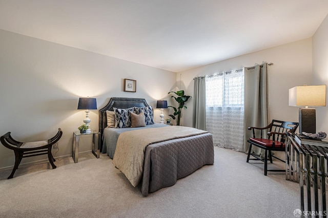 bedroom featuring baseboards and carpet