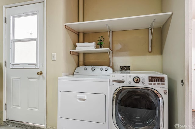 clothes washing area featuring laundry area and washing machine and dryer