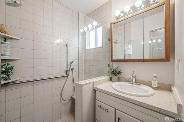 bathroom with walk in shower and vanity