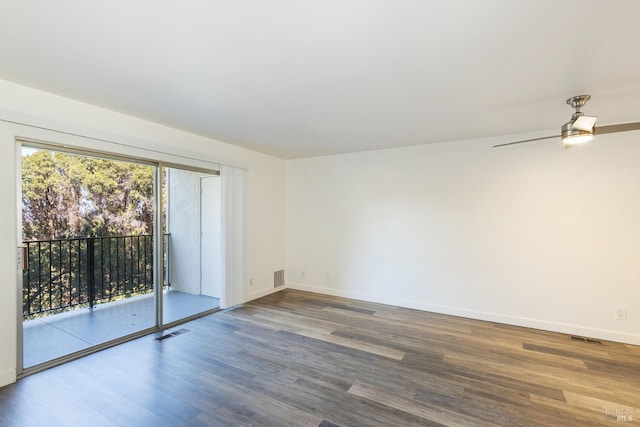 unfurnished room with visible vents, baseboards, and wood finished floors