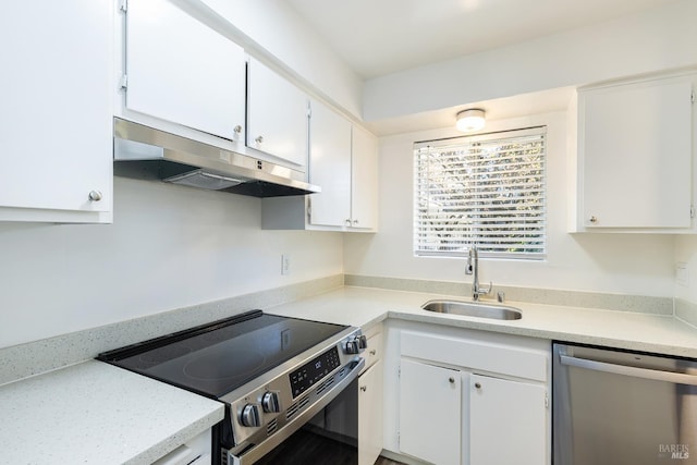 kitchen with under cabinet range hood, appliances with stainless steel finishes, and white cabinets