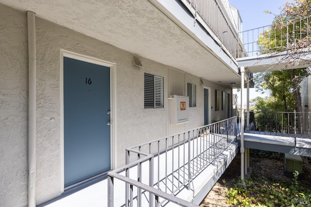 doorway to property with stucco siding