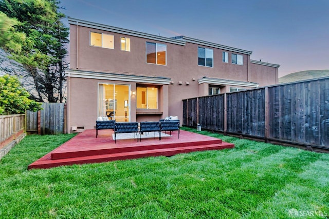 32 Highcrest Ln, South San Francisco, CA 94080 - back of house at dusk featuring a wooden deck, outdoor lounge area, and stucco siding