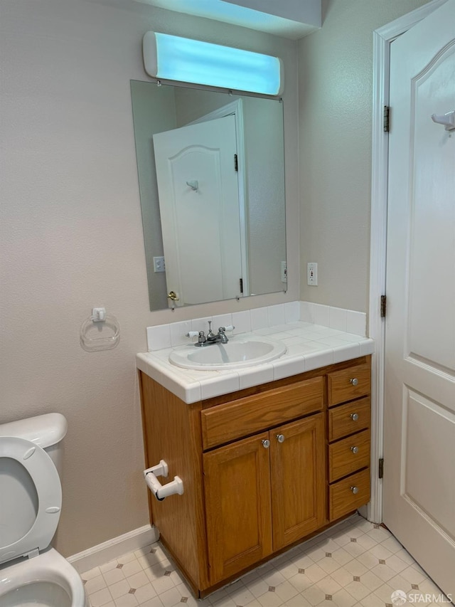 bathroom featuring toilet and vanity