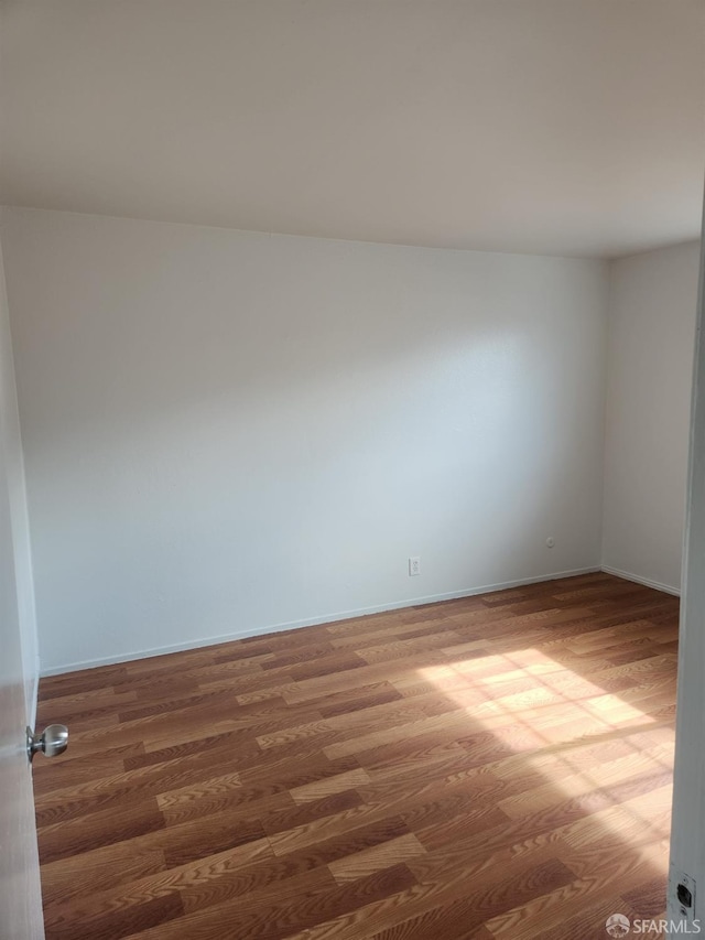 spare room featuring dark hardwood / wood-style floors