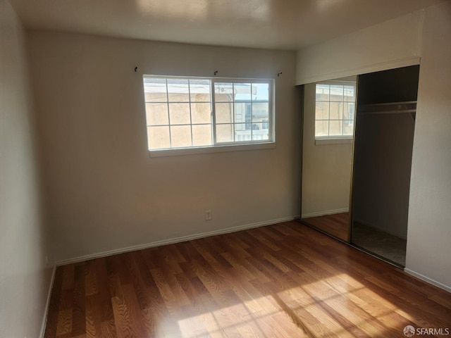 unfurnished bedroom featuring a closet and light hardwood / wood-style floors