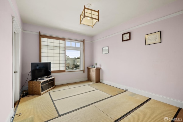 living area featuring baseboards