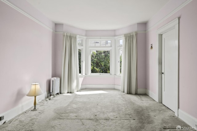 interior space with radiator and baseboards