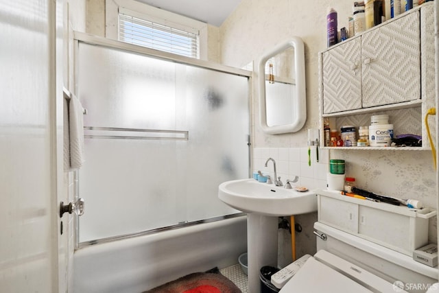 full bathroom with bath / shower combo with glass door