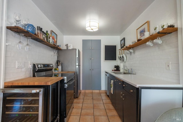 kitchen featuring wine cooler, appliances with stainless steel finishes, open shelves, and a sink