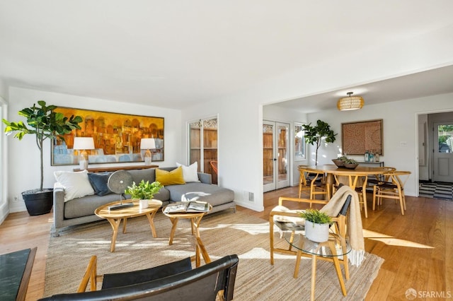 living room featuring light hardwood / wood-style floors and french doors