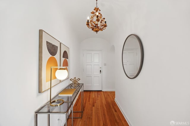 1101 Green St Unit 1402, San Francisco, CA 94109 - corridor with a chandelier, wood finished floors, baseboards, and arched walkways