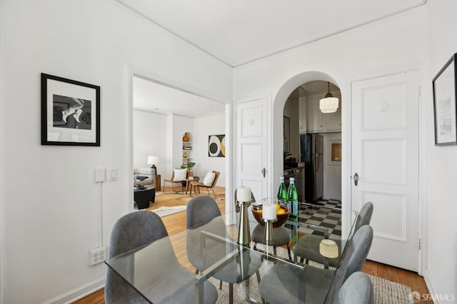 1101 Green St Unit 1402, San Francisco, CA 94109 - dining space featuring arched walkways, wood finished floors, baseboards, and crown molding