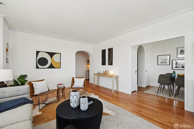 1101 Green St Unit 1402, San Francisco, CA 94109 - living room with arched walkways, crown molding, light wood-type flooring, and baseboards