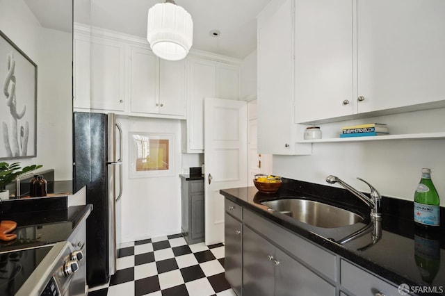 1101 Green St Unit 1402, San Francisco, CA 94109 - kitchen featuring freestanding refrigerator, tile patterned floors, dark countertops, range with electric cooktop, and a sink