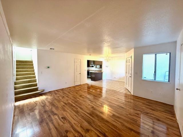80 Portola Way Unit 105, Tracy, CA 95376 - unfurnished living room with wood finished floors and stairs
