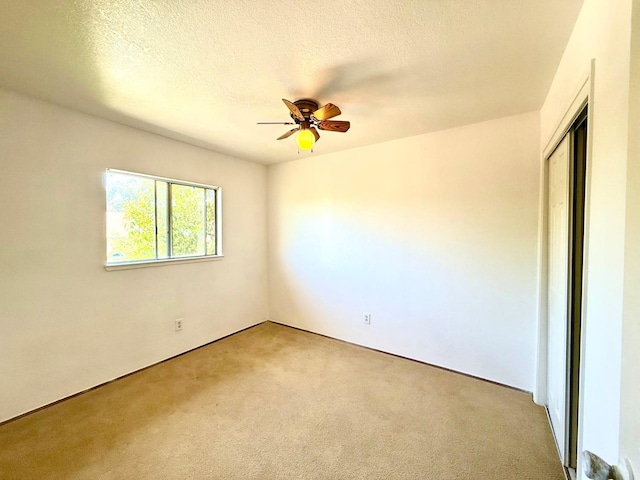 80 Portola Way Unit 105, Tracy, CA 95376 - unfurnished room featuring light colored carpet, a ceiling fan, and a textured ceiling